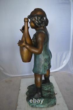 Boy holding a bottle water fountain Size 17L x 14W x 38H