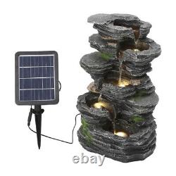 Caractéristique d'eau de jardin extérieure alimentée par l'énergie solaire avec fontaine en cascade en rocaille et lumières.