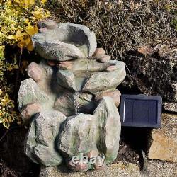 Fontaine extérieure en cascade de roche grise avec alimentation solaire et secteur